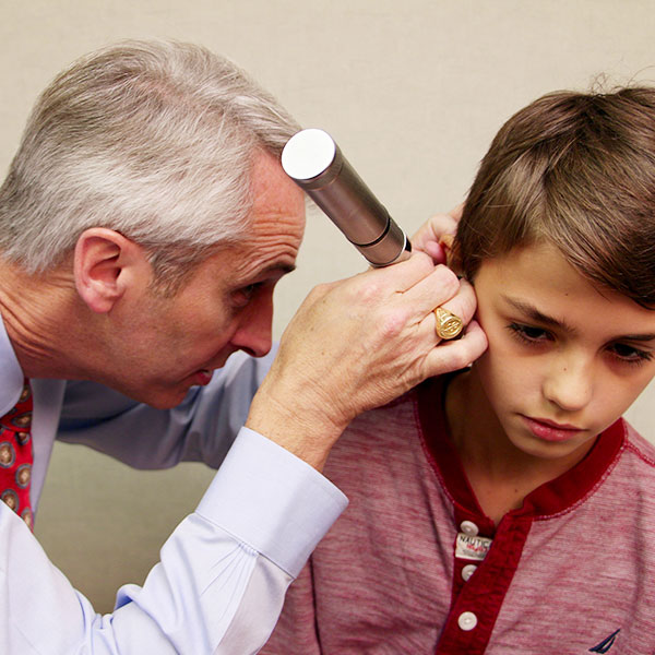 Dr. Greisner examining a patient's ear